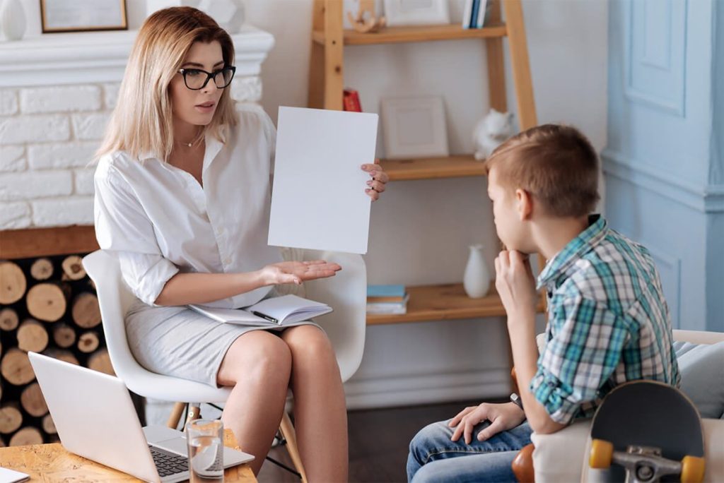 Adult woman shows young child blank document